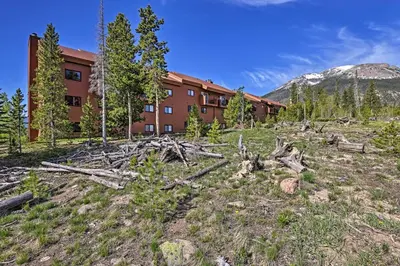 a pile of logs in front of a building at Silverthorne Condo Patio, Mtn Views, Pool Access! in Silverthorne