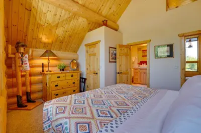 a bedroom with a bed and a wooden ceiling at 7 Mi to Granby Ranch Secluded Cabin with Mtn Views! in Granby