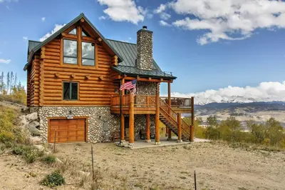 a log cabin with a porch and a deck at 7 Mi to Granby Ranch Secluded Cabin with Mtn Views! in Granby