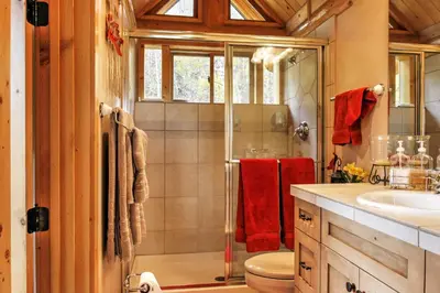 a bathroom with a shower and a toilet and a sink at 7 Mi to Granby Ranch Secluded Cabin with Mtn Views! in Granby