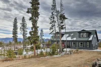 a house in the middle of a field with trees at Mtn-View Retreat with Hot Tub in Granby! in Granby