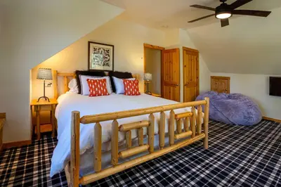 a bedroom with a large bed and a ceiling fan at Mtn-View Retreat with Hot Tub in Granby! in Granby