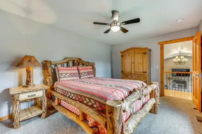 a bedroom with a bed and a ceiling fan at 2 Mi to Downtown Home with Hot Tub in Estes Park! in Estes Park