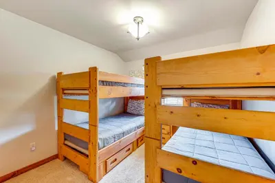 a bedroom with two bunk beds in a house at 2 Mi to Downtown Home with Hot Tub in Estes Park! in Estes Park