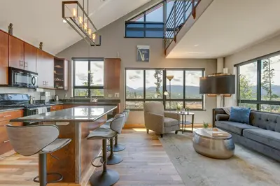 a kitchen and living room with a couch and a table at Fraser House with Mtn Views Near Winter Park! in Fraser