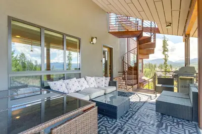 a living room with a couch on a balcony at Fraser House with Mtn Views Near Winter Park! in Fraser