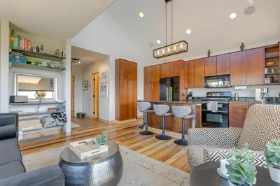 a living room with a couch and a kitchen at Fraser House with Mtn Views Near Winter Park! in Fraser