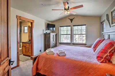 a bedroom with a bed and a ceiling fan at Winter Park Condo with Hot Tub and Mountain Views! in Winter Park