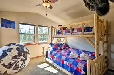 a bedroom with a bunk bed and a bed at Winter Park Condo with Hot Tub and Mountain Views! in Winter Park
