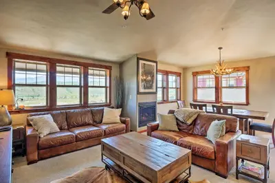 a living room with leather couches and a coffee table at Winter Park Condo with Hot Tub and Mountain Views! in Winter Park