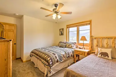 a bedroom with two beds and a ceiling fan at Steps to Grand Lake Condo with Deck and Mtn Views in Grand Lake