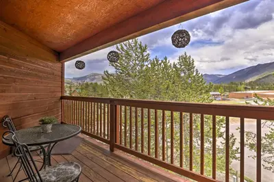a balcony with a table and chairs and a view at Steps to Grand Lake Condo with Deck and Mtn Views in Grand Lake