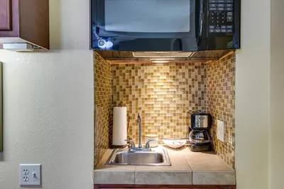 a kitchen with a sink and a microwave at Half-Mi to Light Rail Greenwood Village Studio in Englewood