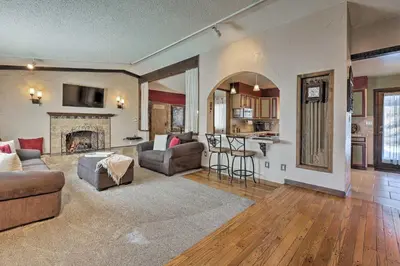 a living room with a couch and a fireplace at Arvada Home with Deck and Game Room Near Olde Town! in Arvada