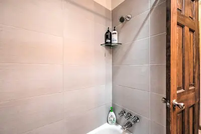 a bathroom with a sink and a shower at Arvada Home with Deck and Game Room Near Olde Town! in Arvada