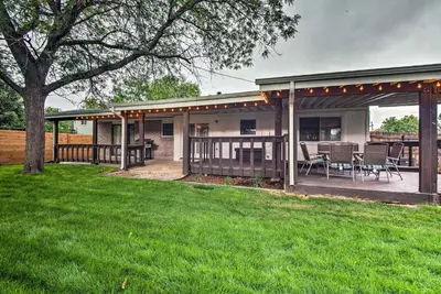 a house with a patio with a table and chairs at Arvada Home with Deck and Game Room Near Olde Town! in Arvada