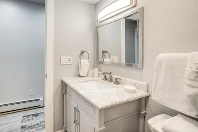 a white bathroom with a sink and a mirror at Pet-Friendly Apt with Views 6 Mi to Keystone Resort in Silverthorne