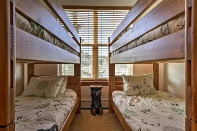 a bedroom with two bunk beds and a window at Winter Park Condo Hot Tub and Shuttle-Walk to Town in Winter Park