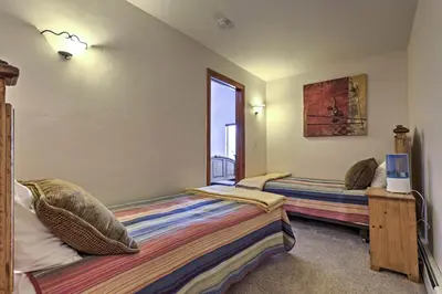 a bedroom with two beds and a window at Winter Park Condo Hot Tub and Shuttle-Walk to Town in Winter Park