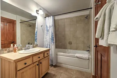 a bathroom with a sink and a bath tub at Winter Park Condo Hot Tub and Shuttle-Walk to Town in Winter Park