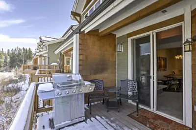 a patio with a stove on a house at Winter Park Condo Hot Tub and Shuttle-Walk to Town in Winter Park