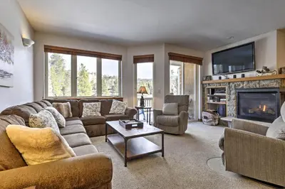 a living room with a couch and a fireplace at Winter Park Condo Hot Tub and Shuttle-Walk to Town in Winter Park