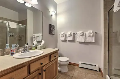 a bathroom with a sink and a toilet and a shower at Winter Park Condo Hot Tub and Shuttle-Walk to Town in Winter Park