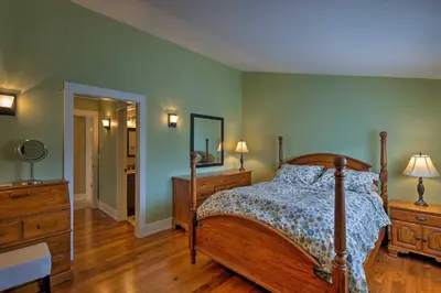 a bedroom with a bed and two dressers and a mirror at Mtn-View Home with Deck Walk to Dtwn Frisco! in Frisco