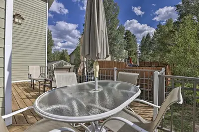 a table and chairs on a deck with an umbrella at Mtn-View Home with Deck Walk to Dtwn Frisco! in Frisco