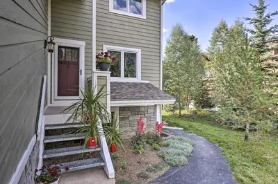 a house with a door and a porch with flowers at Mtn-View Home with Deck Walk to Dtwn Frisco! in Frisco