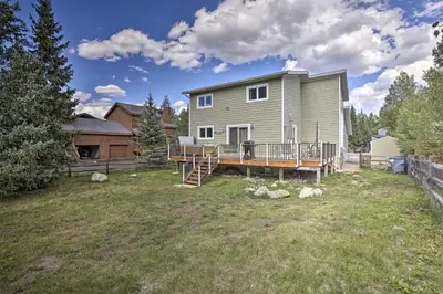 a large yard with a house with a deck at Mtn-View Home with Deck Walk to Dtwn Frisco! in Frisco