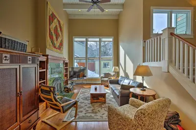 a living room with a couch and a table at Mtn-View Home with Deck Walk to Dtwn Frisco! in Frisco