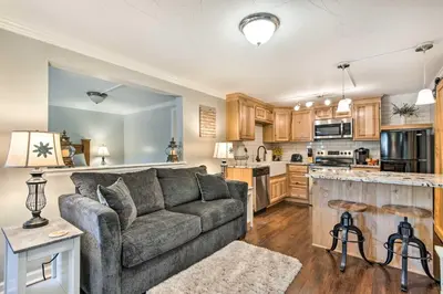 a living room with a couch and a kitchen at 11 Mi to Denver Zoo Lakewood Studio with Fire Pit! in Lakewood