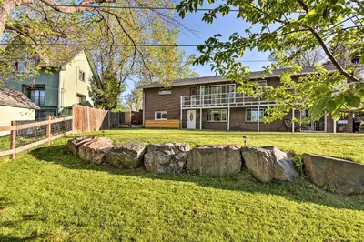 a house with a yard with rocks in front of it at 11 Mi to Denver Zoo Lakewood Studio with Fire Pit! in Lakewood