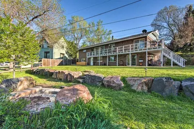 a large house with rocks in front of it at 11 Mi to Denver Zoo Lakewood Studio with Fire Pit! in Lakewood