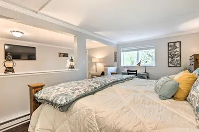 a bedroom with a bed and a tv on the wall at 11 Mi to Denver Zoo Lakewood Studio with Fire Pit! in Lakewood