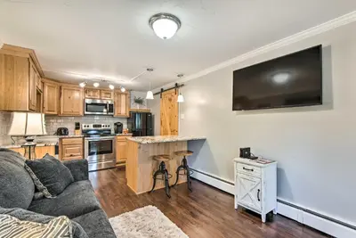 a living room with a couch and a kitchen at 11 Mi to Denver Zoo Lakewood Studio with Fire Pit! in Lakewood