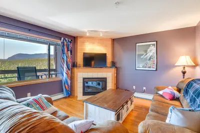 a living room with two couches and a fireplace at Stunning Mountain Views Silverthorne Condo! in Silverthorne