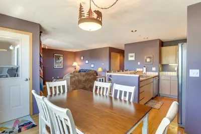 a kitchen and dining room with a table and chairs at Stunning Mountain Views Silverthorne Condo! in Silverthorne