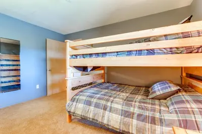 a bedroom with bunk beds in a house at Stunning Mountain Views Silverthorne Condo! in Silverthorne