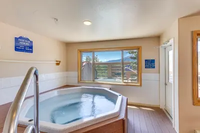 a jacuzzi tub in a room with a window at Stunning Mountain Views Silverthorne Condo! in Silverthorne