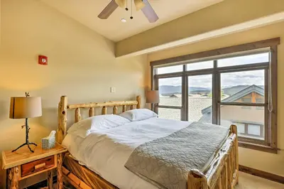 a bedroom with a bed and a large window at Elegant Frisco Condo with Private Hot Tub and Views! in Frisco