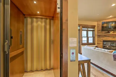 a living room with a sliding door with a couch at Elegant Frisco Condo with Private Hot Tub and Views! in Frisco