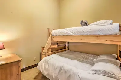 a bedroom with two bunk beds with a dog sitting on top at Elegant Frisco Condo with Private Hot Tub and Views! in Frisco