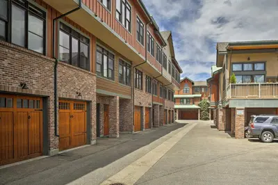 an empty street with cars parked in front of buildings at Elegant Frisco Condo with Private Hot Tub and Views! in Frisco