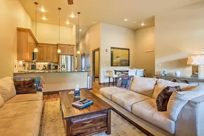a living room with a couch and a table at Elegant Frisco Condo with Private Hot Tub and Views! in Frisco