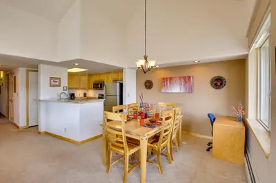 a kitchen and dining room with a table and chairs at 360 Mtn Views and Shared Hot Tub Cozy Frisco Condo! in Frisco