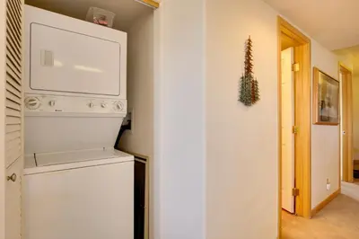 a kitchen with a washer and dryer in a room at 360 Mtn Views and Shared Hot Tub Cozy Frisco Condo! in Frisco