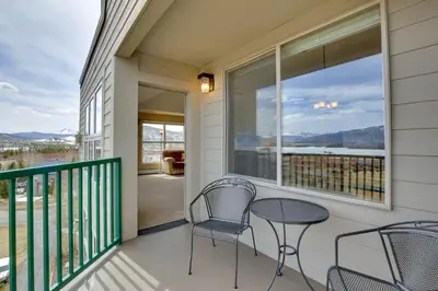 a balcony with two chairs and a table and a window at 360 Mtn Views and Shared Hot Tub Cozy Frisco Condo! in Frisco