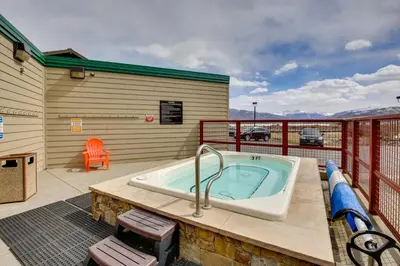 a jacuzzi tub on the deck of a house at 360 Mtn Views and Shared Hot Tub Cozy Frisco Condo! in Frisco